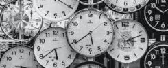 a black and white image of a collection of clocks