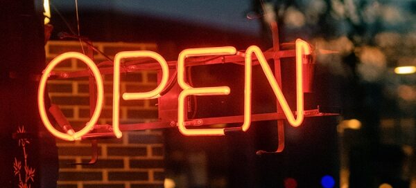 a dark image with a glowing OPEN sign